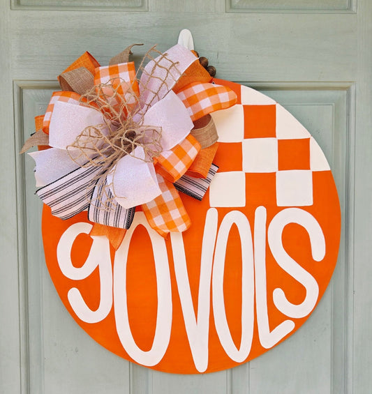Hand-painted Tennessee Vols door hanger in orange and white with checkerboard design and layered ribbon bow